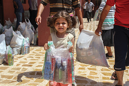 Iraqi refugee girl receives hygiene kit.